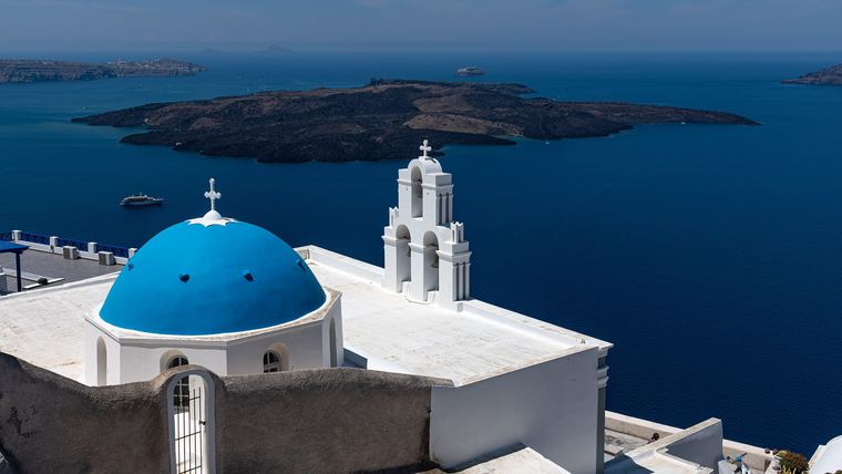 A blue-painted domed roof on Santorini, the vaulted roof construction that roofing and waterproofing work on the island has to seal before winter