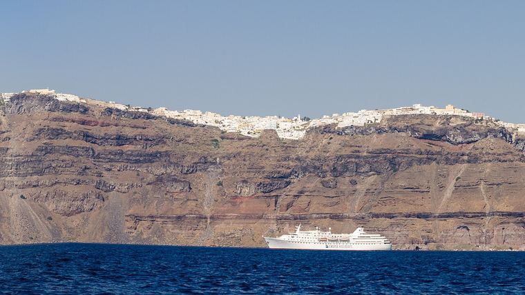 The caldera rim of Santorini with Imerovigli, Firostefani and Fira strung along the cliff edge, the settlements most construction work on the island takes place in