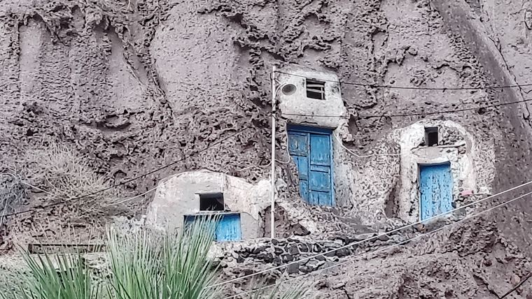 Cave houses cut into the volcanic rock on Santorini, showing the yposkafo building stock that most renovation work on the island deals with
